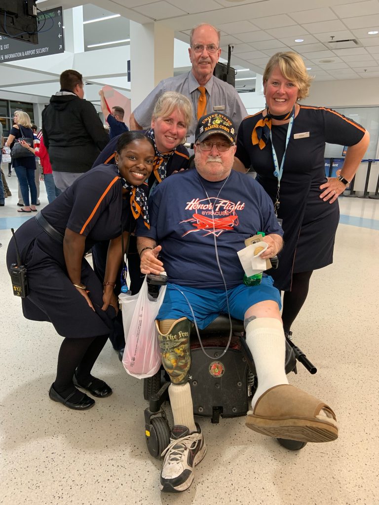 Veteran in wheel chair with friends